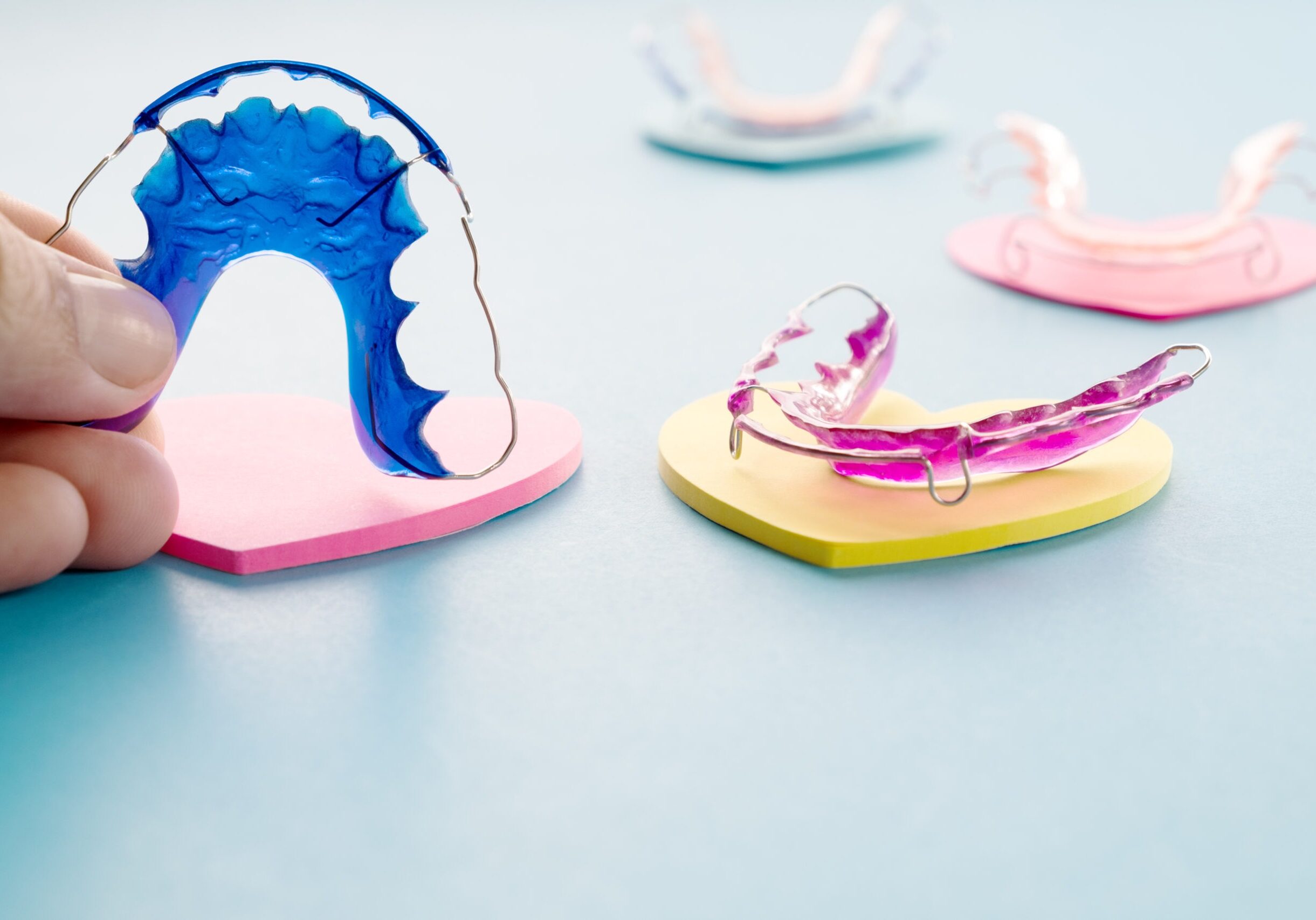 Dental retainer orthodontic appliance on the blue background.